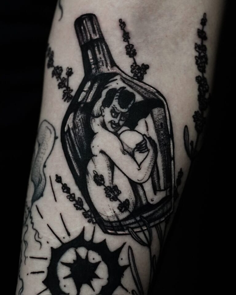 7sinstattoo.live W wyjątkowym pokazie artyzmu, DSC09899 przedstawia czarno-biały tatuaż na ramieniu, przedstawiający osobę zwiniętą w butelce, otoczoną elementami dekoracyjnymi, takimi jak kwiaty i abstrakcyjne kształty. Ten skomplikowany projekt podkreśla umiejętności tatuażysty Poznań w jednym z najlepszych studiów tatuażu Poznań. Najlepsze studio tatuażu Seven Sins Tattoo